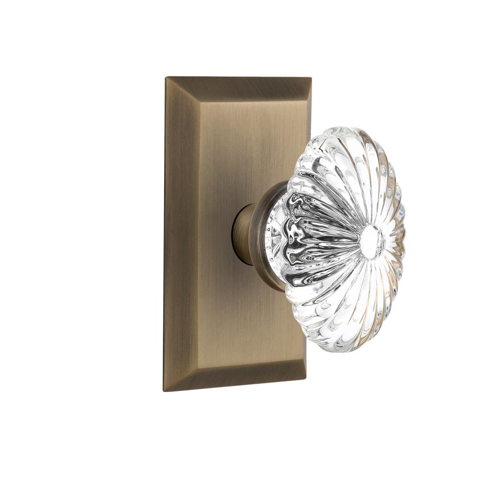 Nostalgic Warehouse STUOFC Single Dummy Knob Studio Plate with Oval Fluted Crystal Knob in Antique Brass